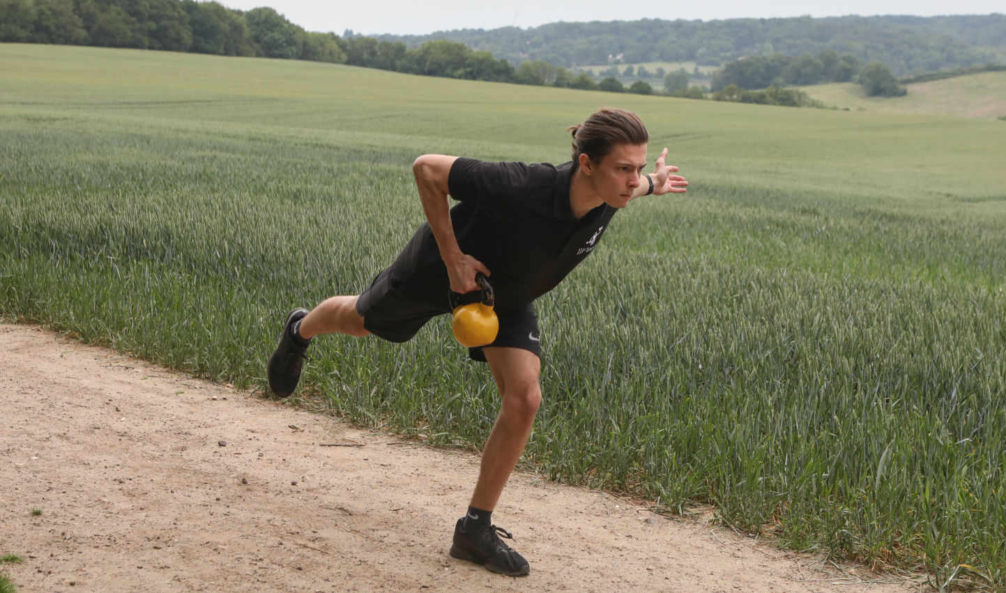 Chris exercising with a kettle bell