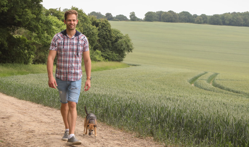 Jonathan walking along a path with his dog Penny