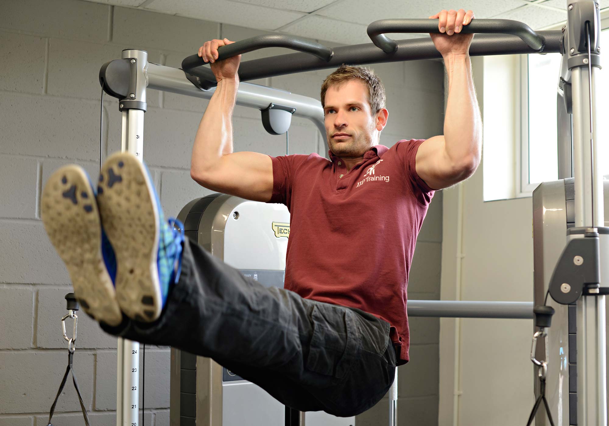 Jonathan performing a pull up on some gym equipment