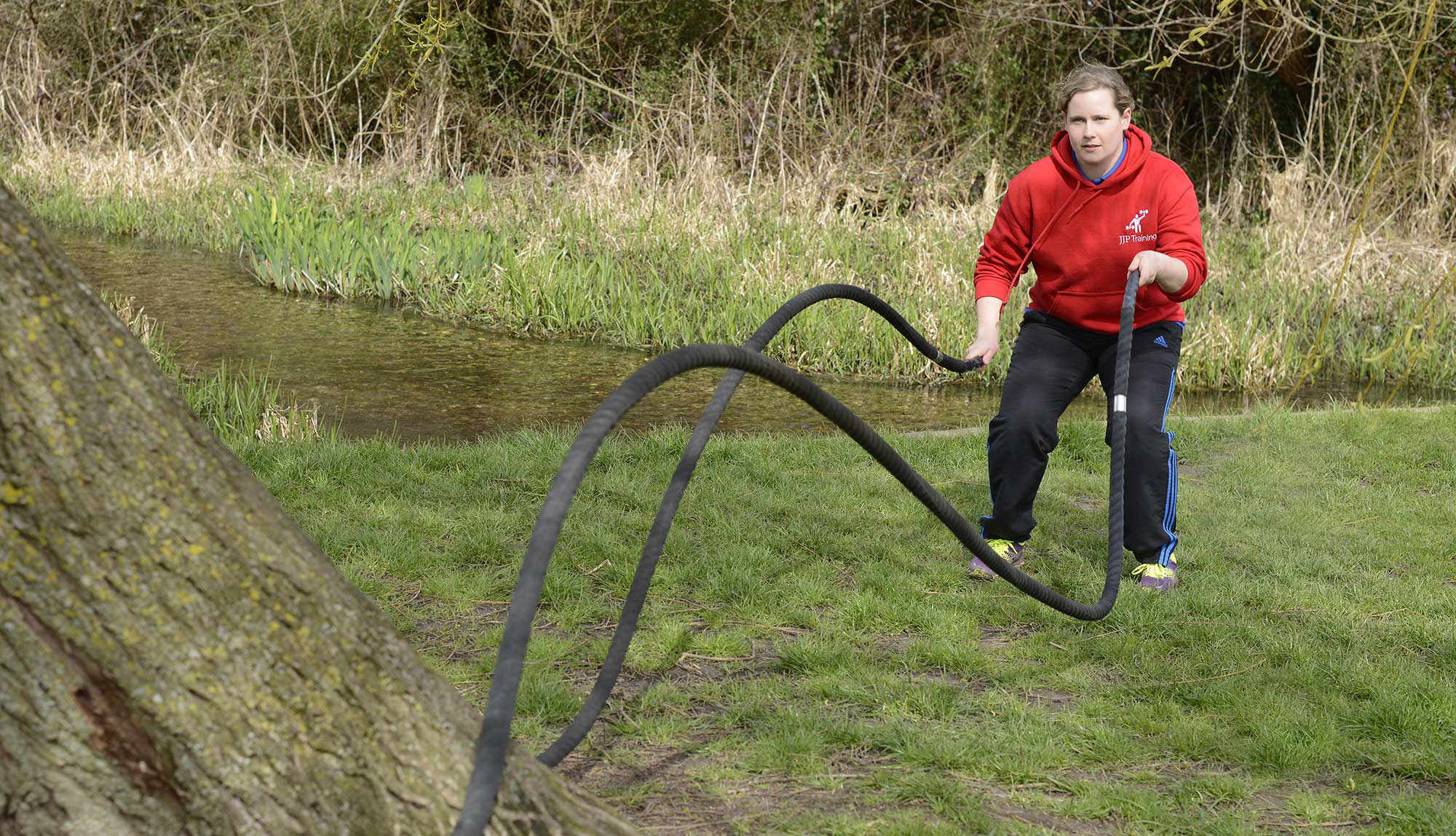 Bex using the weighted ropes around a tree by a stream